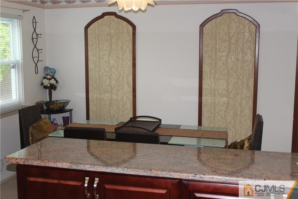 7 Lydia Lane Edison, NJ 08817 - Photo 9 of 17 a room with a granite countertop sink and a mirror