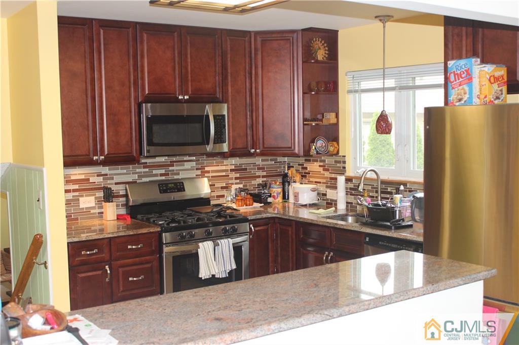 7 Lydia Lane Edison, NJ 08817 - Photo 10 of 17 a kitchen with stainless steel appliances granite countertop a stove a sink and a microwave