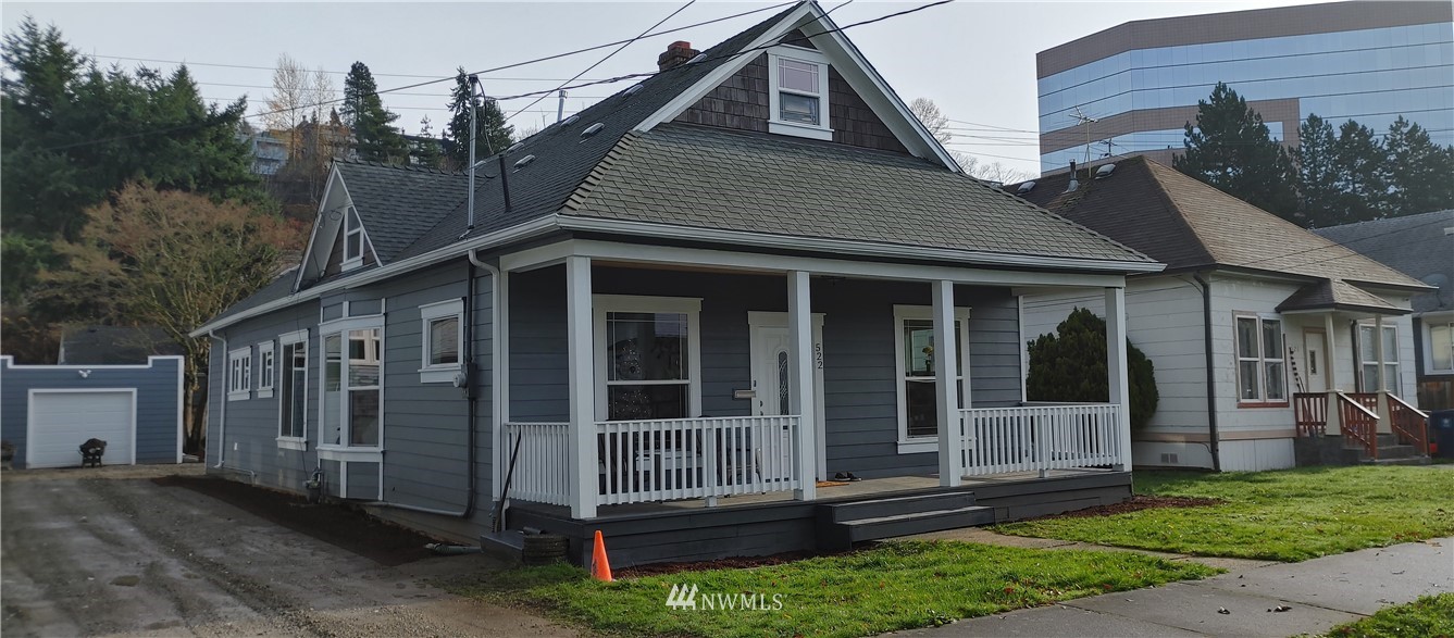 522 Wells Avenue South Renton, WA 98057 - Photo 1 of 19 a view of a house with a yard and wooden fence