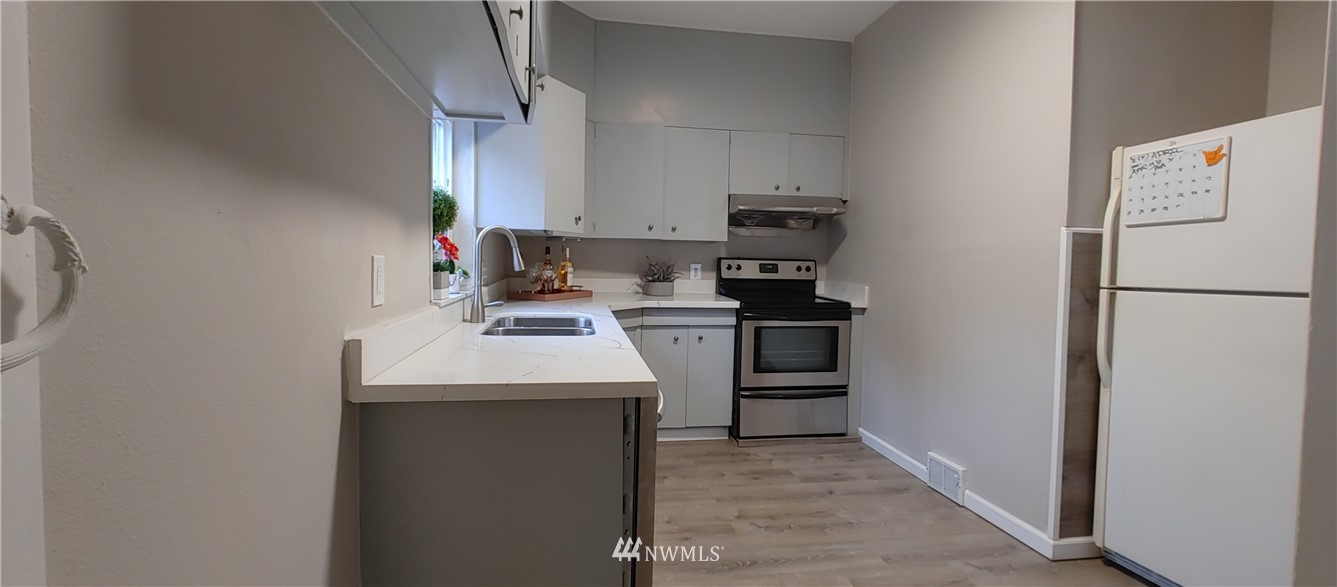 522 Wells Avenue South Renton, WA 98057 - Photo 12 of 19 a kitchen with a sink a stove and refrigerator