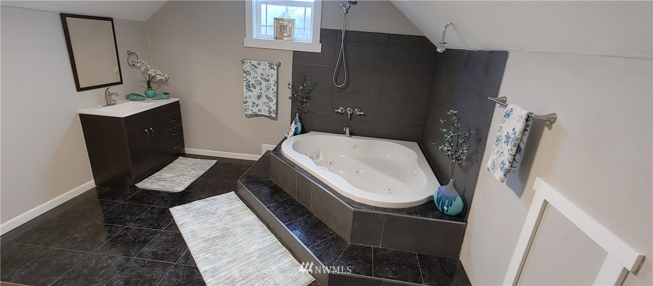 522 Wells Avenue South Renton, WA 98057 - Photo 14 of 19 a white toilet sitting next to a bathroom sink and vanity