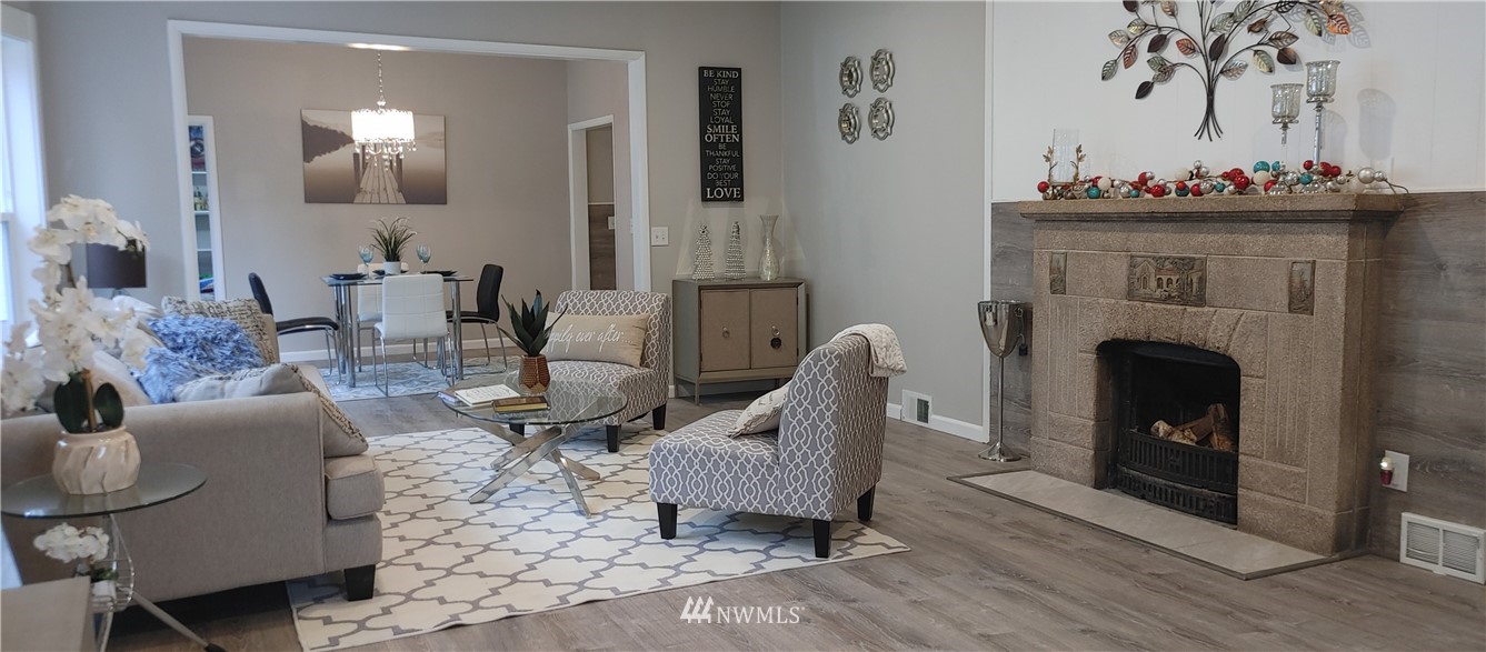 522 Wells Avenue South Renton, WA 98057 - Photo 5 of 19 a living room with furniture and a fireplace