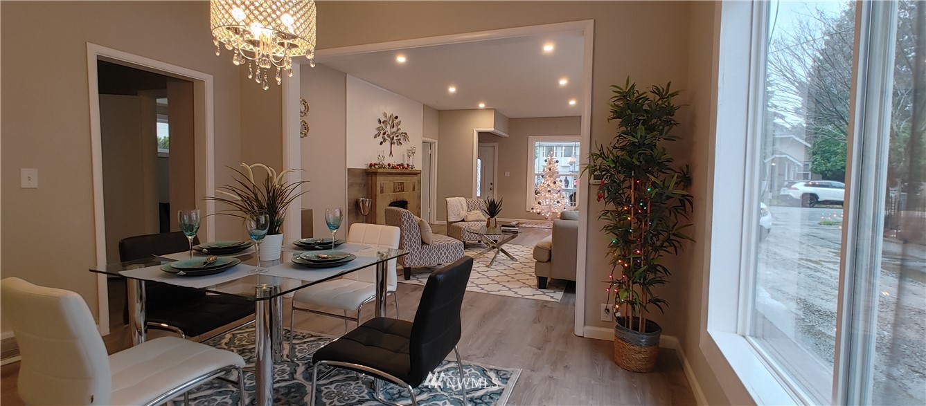 522 Wells Avenue South Renton, WA 98057 - Photo 7 of 19 a view of a dining room with furniture and chandelier