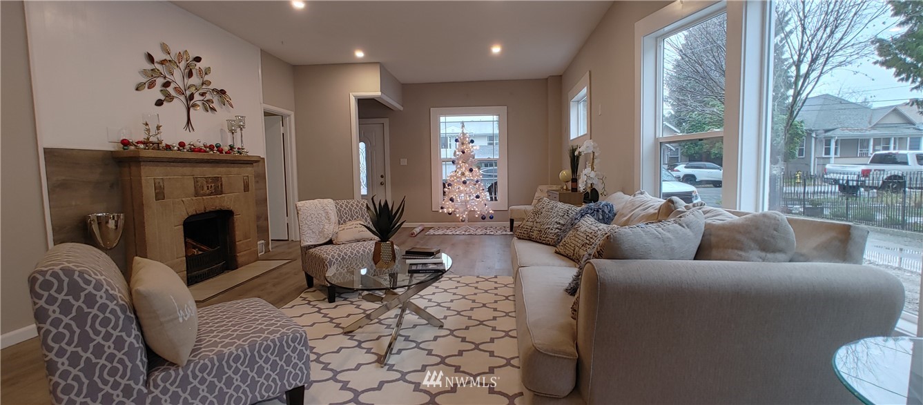 522 Wells Avenue South Renton, WA 98057 - Photo 9 of 19 a living room with furniture large window and a fireplace