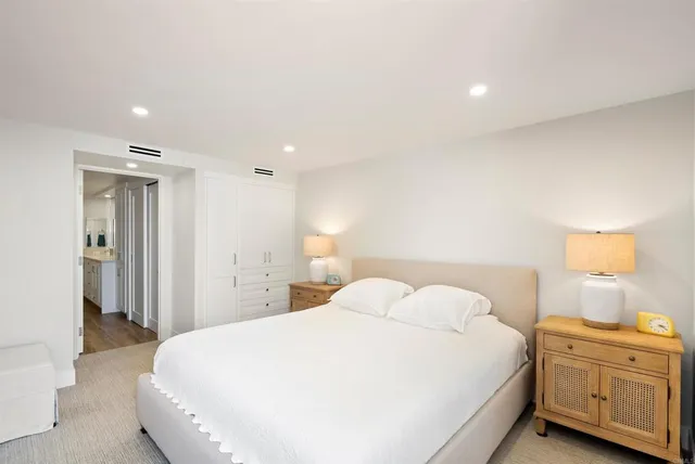 a bedroom with a bed and a night stand