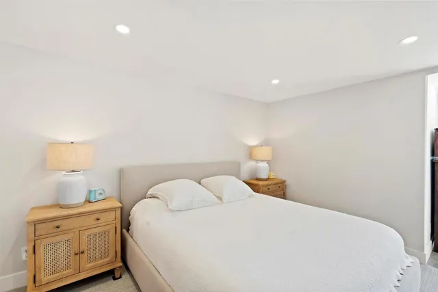 a bedroom with a bed and a night stand