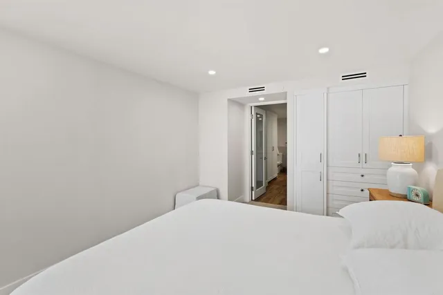 a bedroom with a bed and a lamp