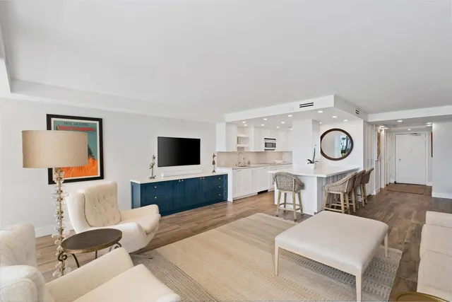 a living room with furniture a flat screen tv and rug