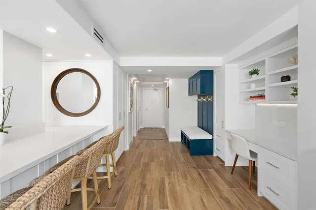 a view of a room with wooden floor and white walls