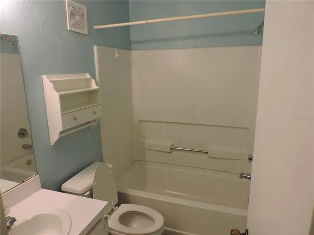a bathroom with a shower and a toilet