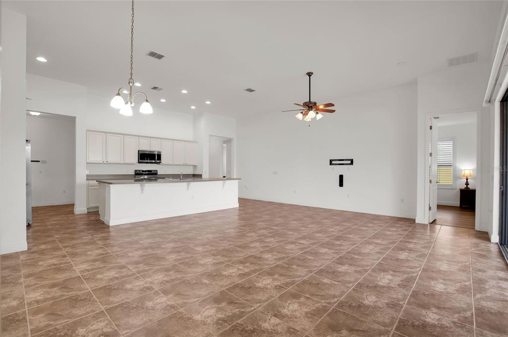 531 Villa Park Road Kissimmee, FL 34759 - Photo 11 of 63 a view of a kitchen with kitchen island wooden floor center island and stainless steel appliances