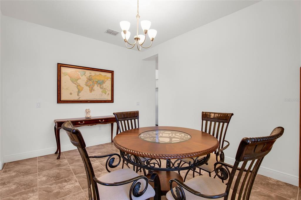 531 Villa Park Road Kissimmee, FL 34759 - Photo 13 of 63 a view of a dining room with furniture and a chandelier