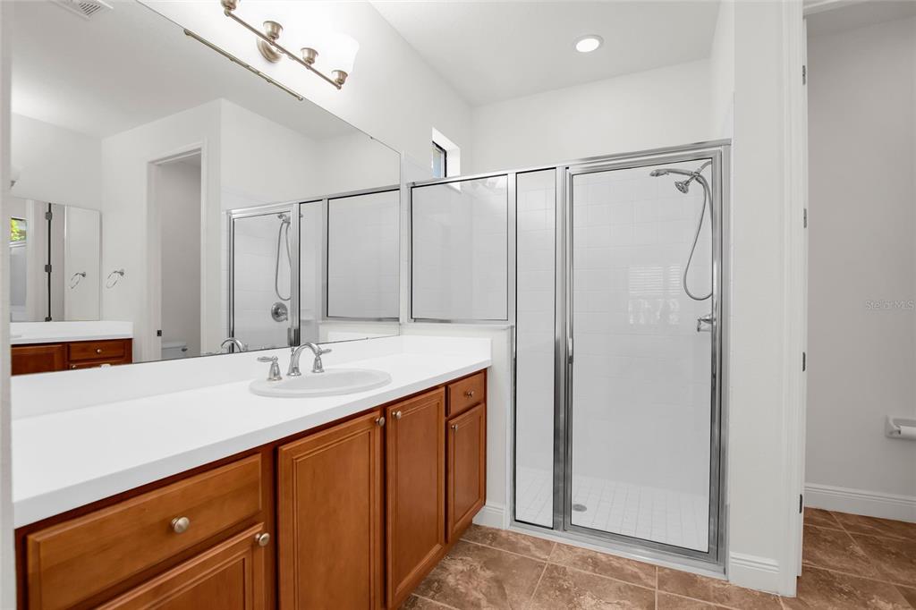 531 Villa Park Road Kissimmee, FL 34759 - Photo 21 of 63 a bathroom with a sink mirror and a shower