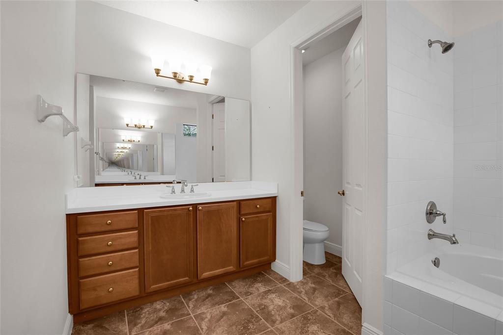 531 Villa Park Road Kissimmee, FL 34759 - Photo 27 of 63 a spacious bathroom with a bathtub sink mirror and toilet