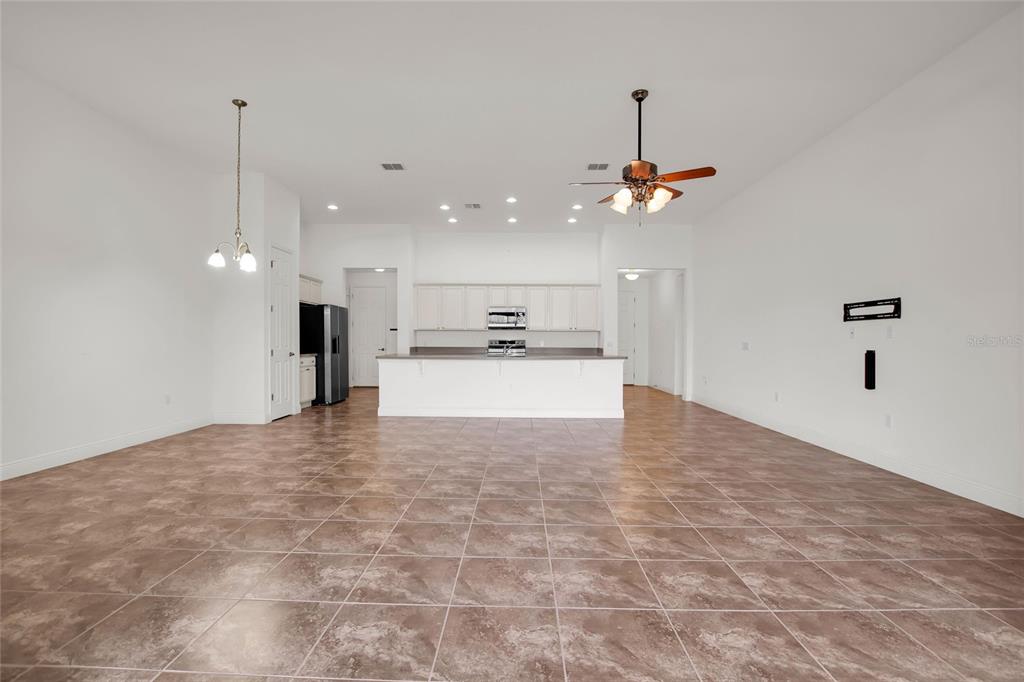 531 Villa Park Road Kissimmee, FL 34759 - Photo 10 of 63 a view of a kitchen with granite countertop a sink and a refrigerator