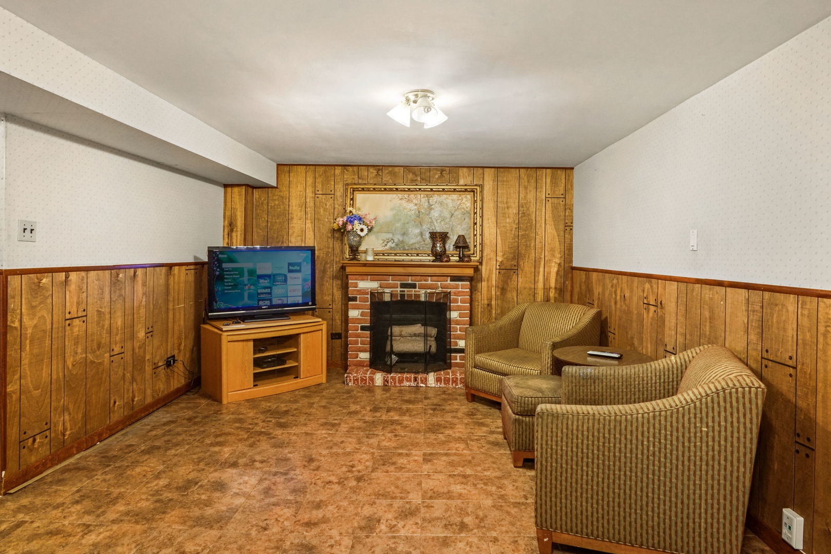1110 Olive Road Homewood, IL 60430 - Photo 11 of 16 a living room with furniture a flat screen tv and a floor to ceiling window