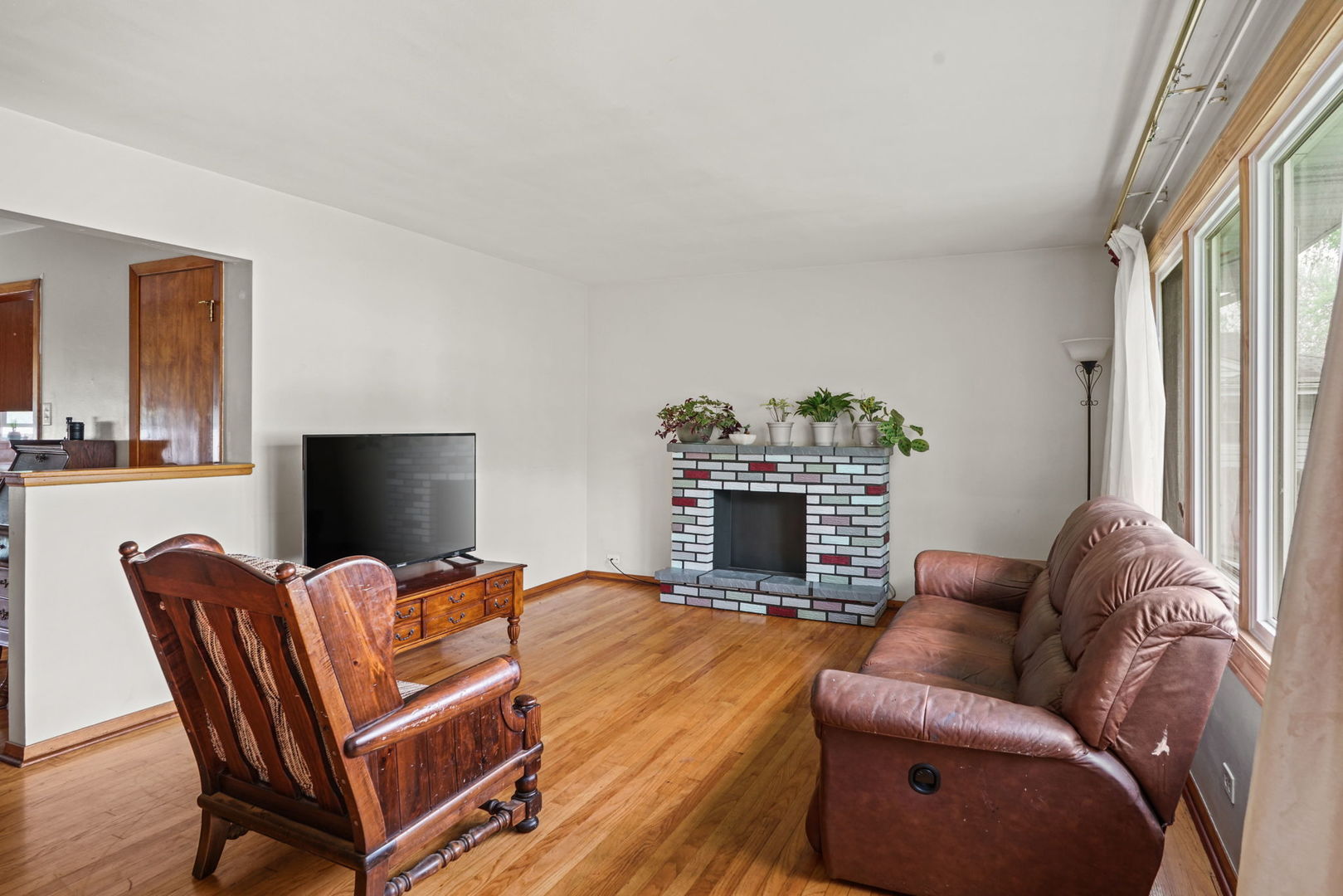 1110 Olive Road Homewood, IL 60430 - Photo 2 of 16 a living room with furniture a fireplace and a flat screen tv