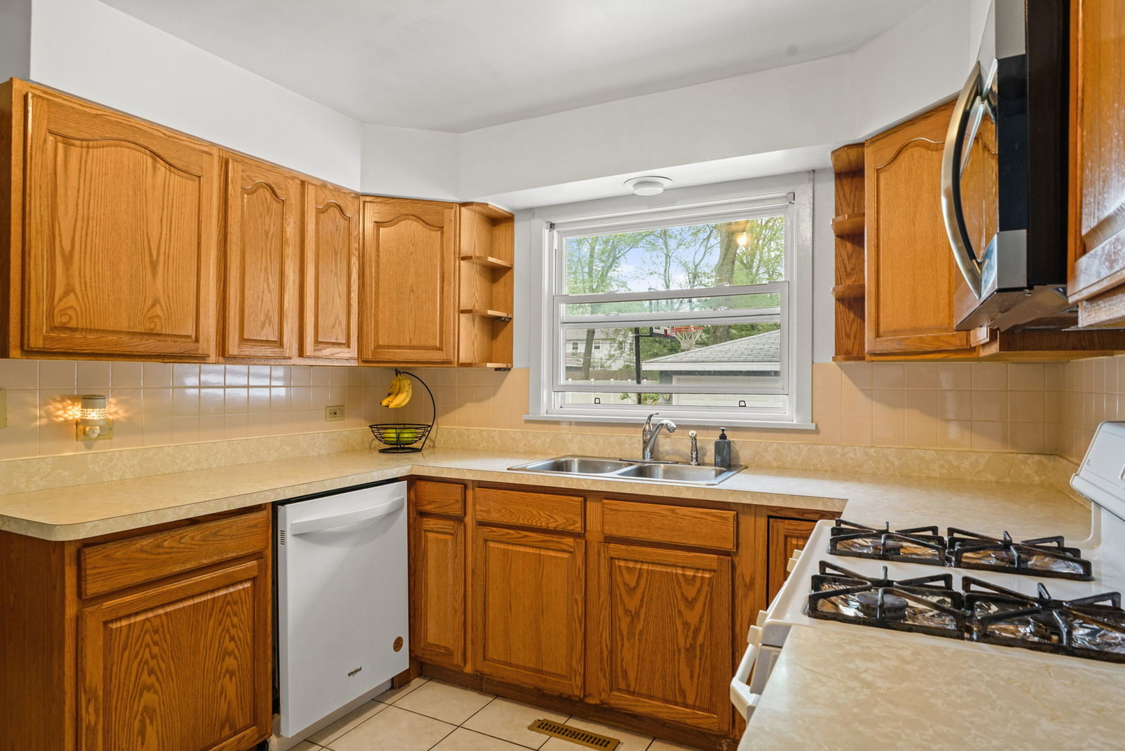 1110 Olive Road Homewood, IL 60430 - Photo 3 of 16 a kitchen with stainless steel appliances granite countertop a sink stove and cabinets