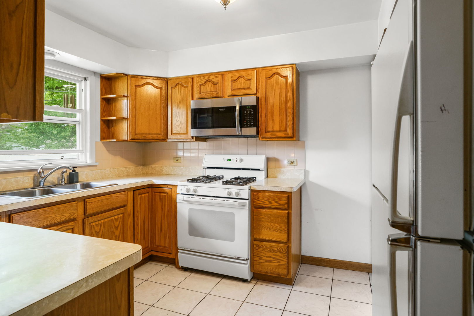 1110 Olive Road Homewood, IL 60430 - Photo 4 of 16 a kitchen with a sink stove and microwave