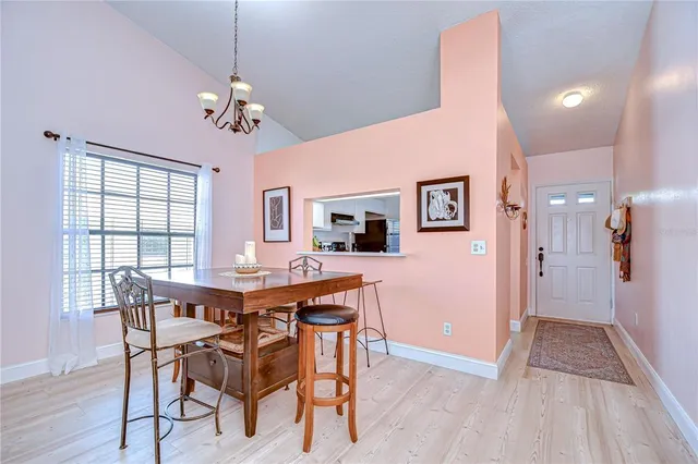 a view of a dining room with furniture and window