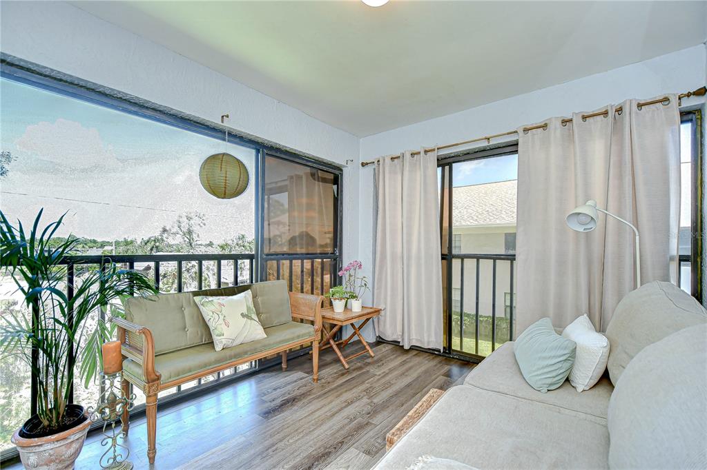 2139 Elm Street, Unit 308 Dunedin, FL 34698 - Photo 17 of 46 a living room with furniture and a floor to ceiling window