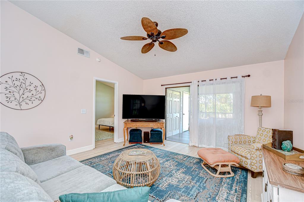 2139 Elm Street, Unit 308 Dunedin, FL 34698 - Photo 22 of 46 a bedroom with furniture and a flat screen tv