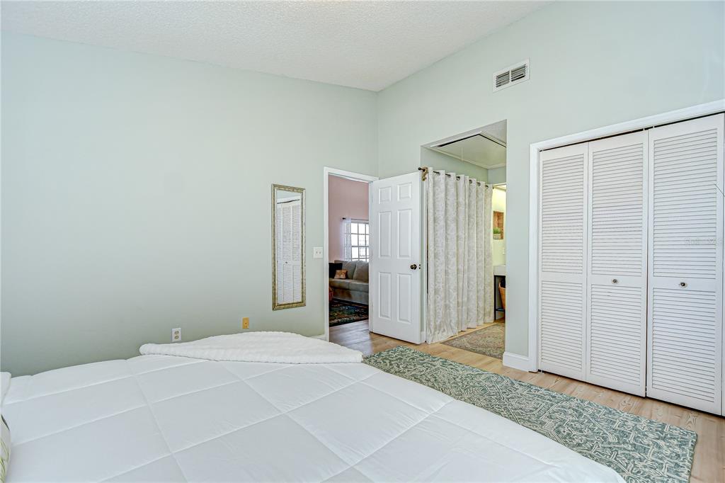 2139 Elm Street, Unit 308 Dunedin, FL 34698 - Photo 24 of 46 a bedroom with a bed and a shower