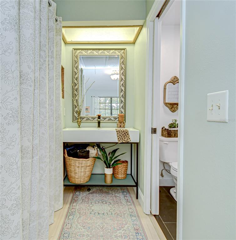 2139 Elm Street, Unit 308 Dunedin, FL 34698 - Photo 25 of 46 a bathroom with a sink and a mirror