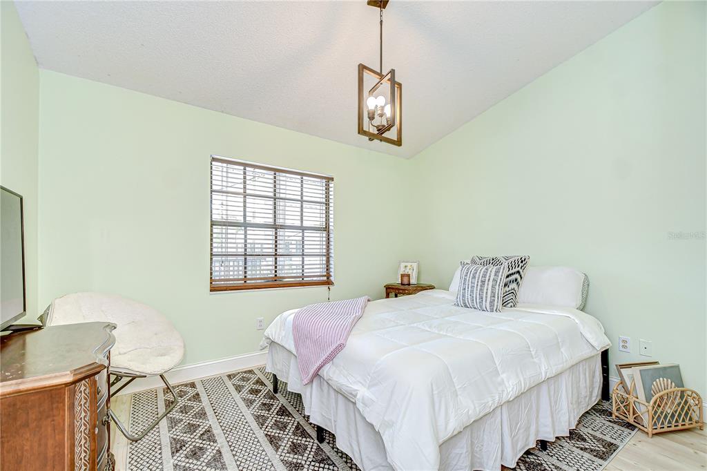 2139 Elm Street, Unit 308 Dunedin, FL 34698 - Photo 27 of 46 a bedroom with a bed and a window