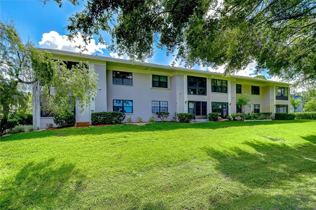 a view of a house with backyard and garden