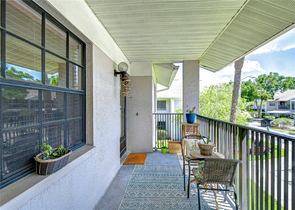 2139 Elm Street, Unit 308 Dunedin, FL 34698 - Photo 6 of 46 a view of porch with furniture and garden