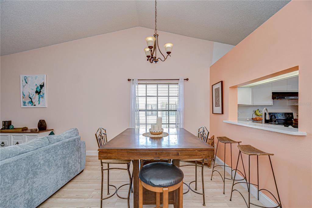2139 Elm Street, Unit 308 Dunedin, FL 34698 - Photo 8 of 46 a view of a dining room with furniture and wooden floor