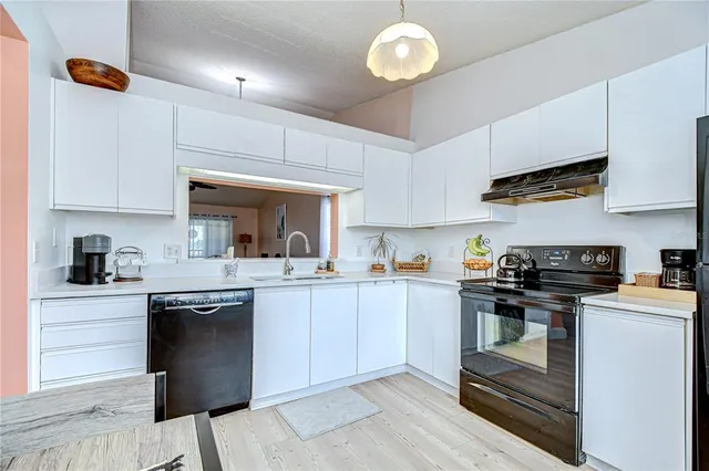 a kitchen with cabinets a sink and stainless steel appliances