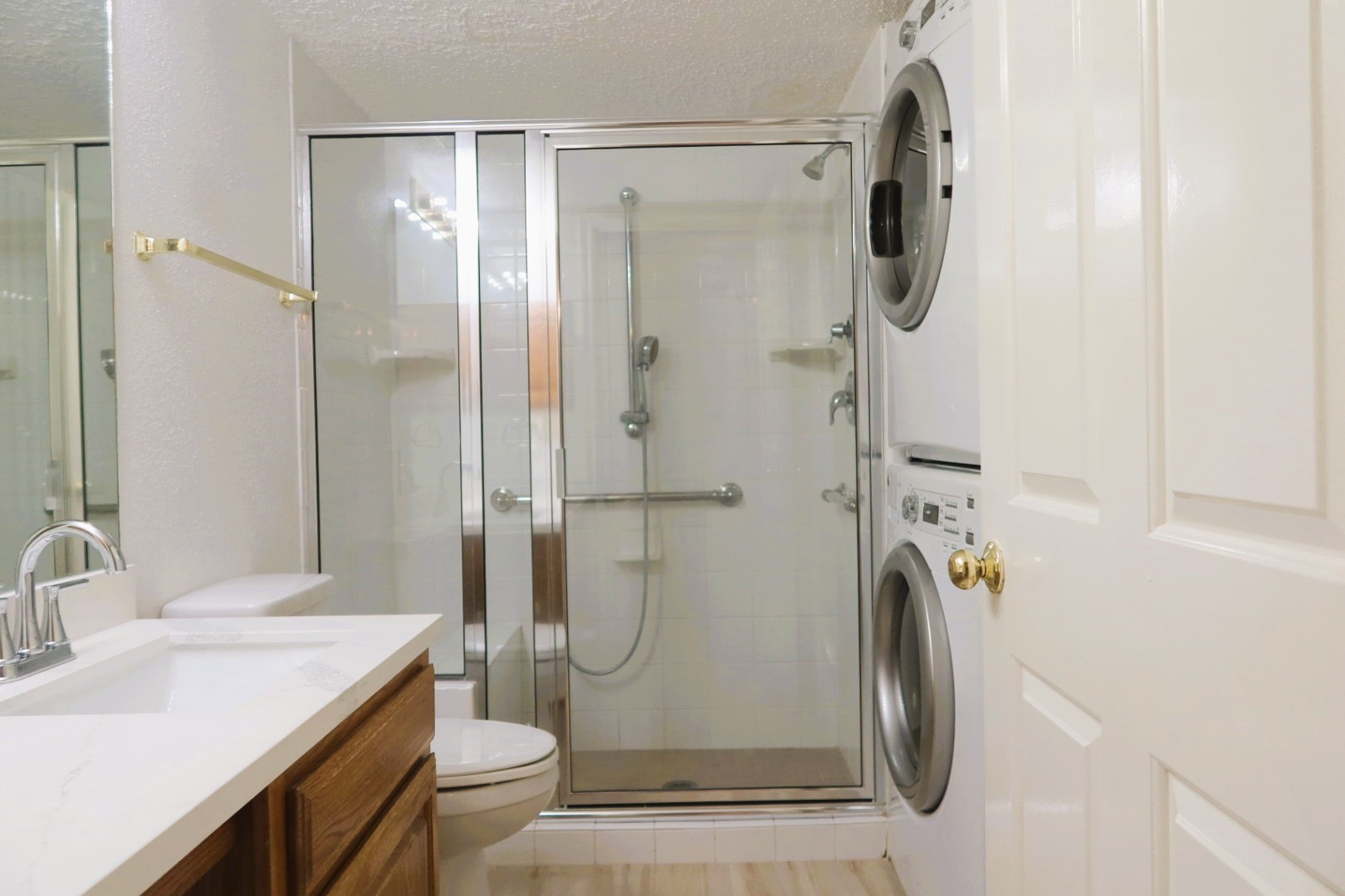 1311 Antoine Drive, Unit 251 Houston, TX 77055 - Photo 20 of 30 a bathroom with a granite countertop shower sink vanity and toilet