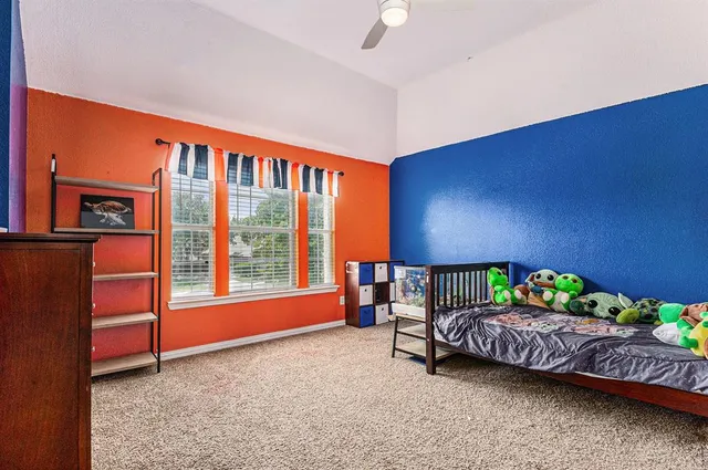 a bedroom with furniture and a lamp