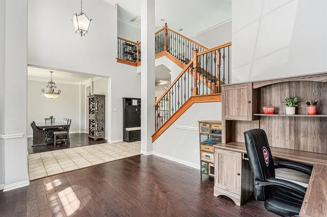 a view of entryway and workspace with wooden floor