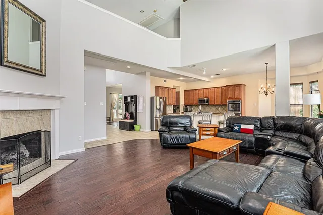 a living room with furniture fireplace and kitchen view