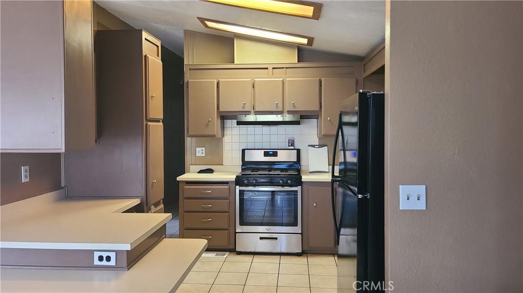 4080 Pedley Road, Unit 49 Jurupa Valley, CA 92509 - Photo 2 of 15 a kitchen with stainless steel appliances granite countertop a refrigerator and a stove top oven