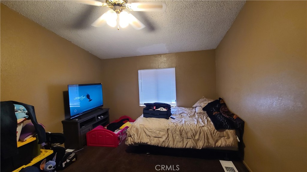 4080 Pedley Road, Unit 49 Jurupa Valley, CA 92509 - Photo 9 of 15 a bedroom with a bed and a chandelier