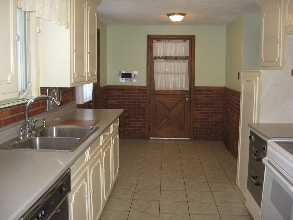 672 Amostown Road West Springfield, MA 01089 - Photo 11 of 30 a kitchen with kitchen island granite countertop a sink stove and cabinets