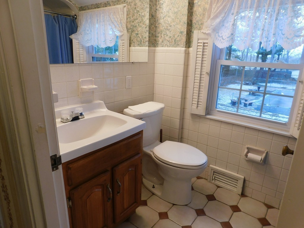 672 Amostown Road West Springfield, MA 01089 - Photo 18 of 30 a bathroom with a sink a toilet and a mirror