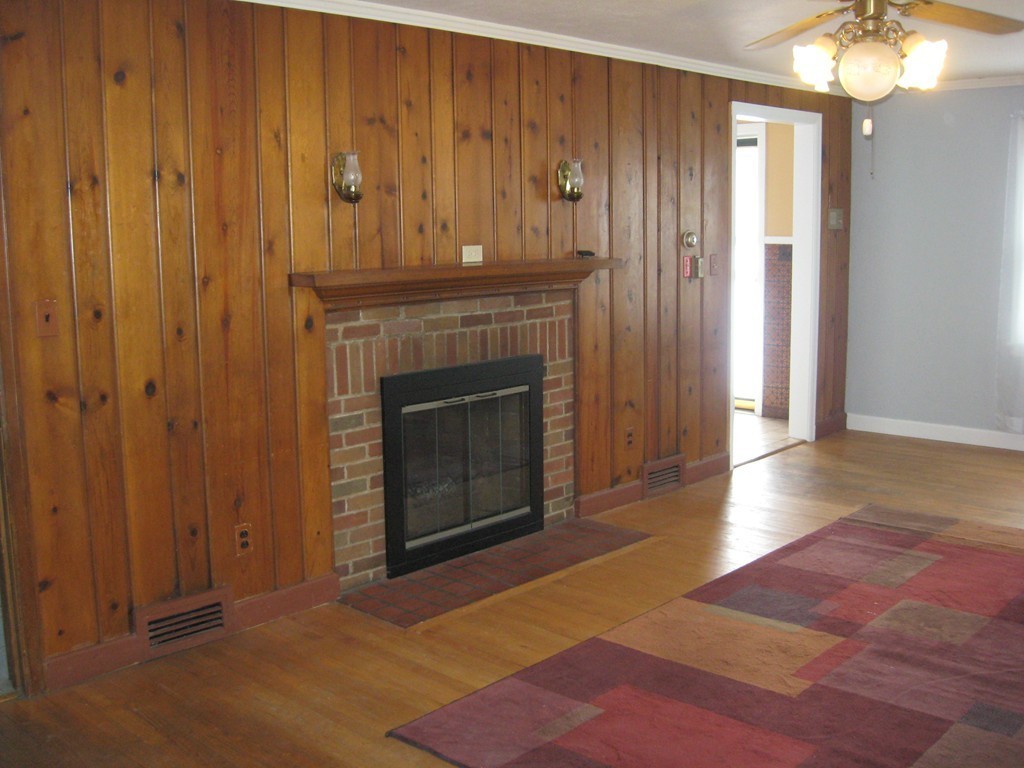 672 Amostown Road West Springfield, MA 01089 - Photo 6 of 30 a view of a livingroom with an empty space and a fireplace