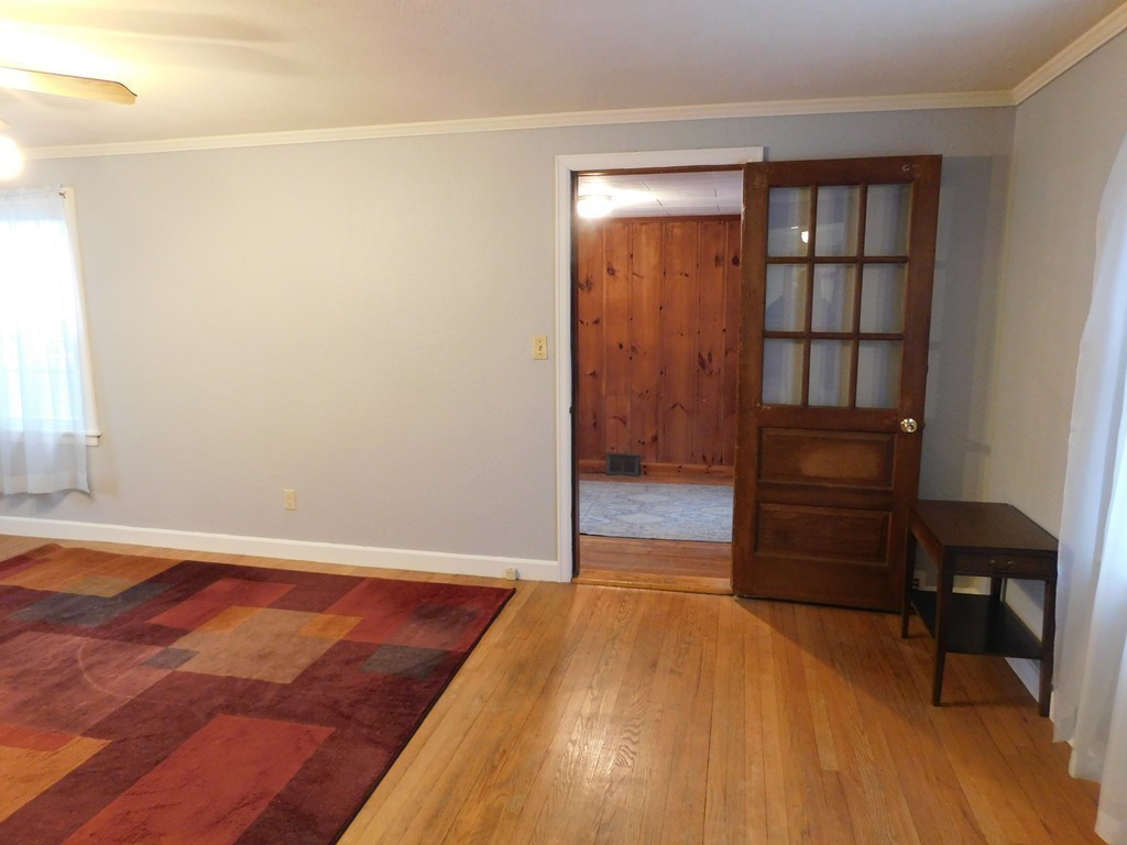 672 Amostown Road West Springfield, MA 01089 - Photo 7 of 30 a view of room with wooden floor and chair