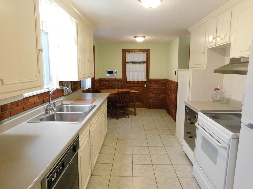 672 Amostown Road West Springfield, MA 01089 - Photo 8 of 30 a kitchen with a sink a counter top space and stainless steel appliances