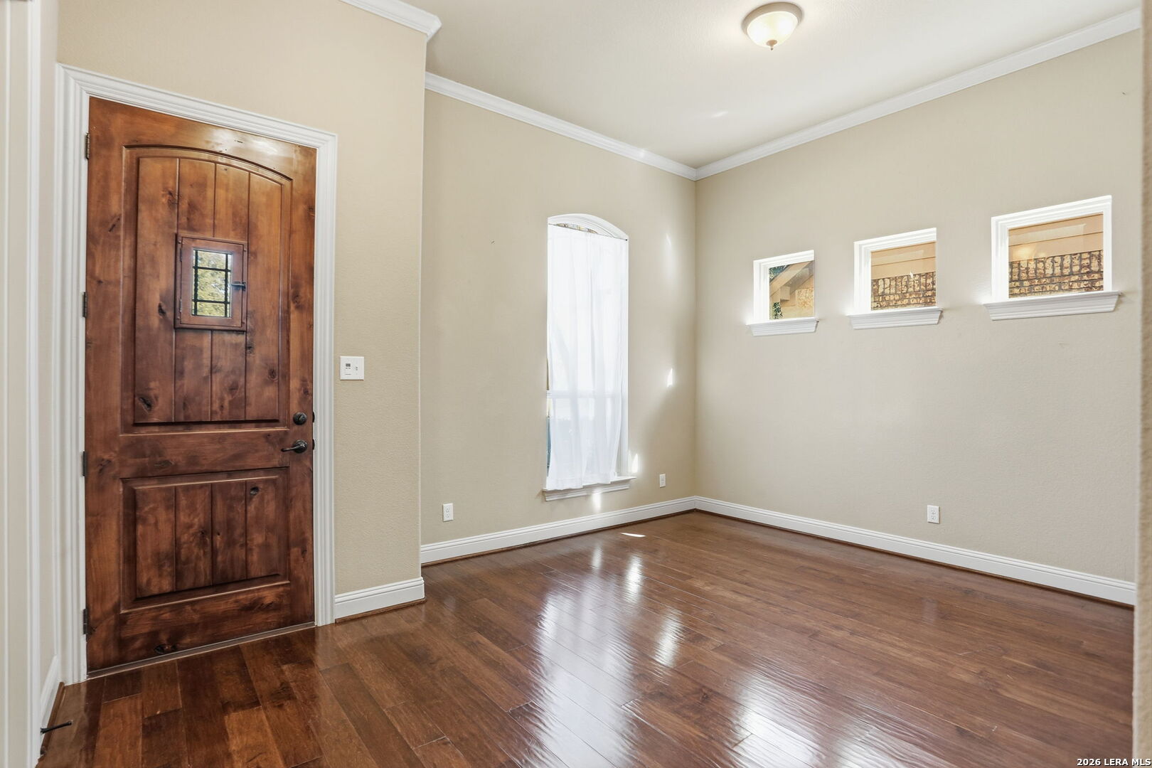27003 Hardy Run Boerne, TX 78015 - Photo 3 of 17 an empty room with wooden floor and windows