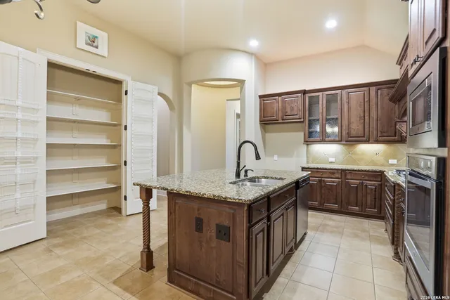 a kitchen with stainless steel appliances granite countertop a stove and a sink