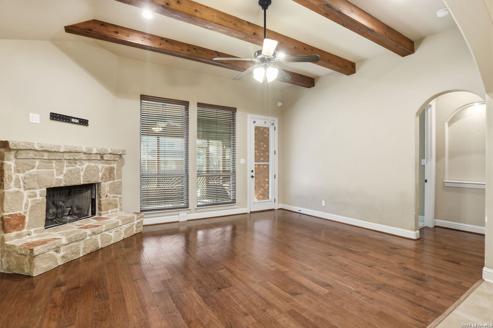 27003 Hardy Run Boerne, TX 78015 - Photo 7 of 17 a view of an empty room with wooden floor fireplace and a window
