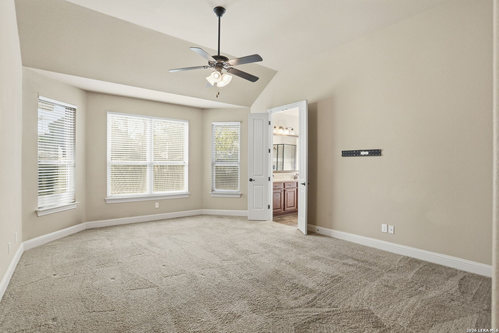 27003 Hardy Run Boerne, TX 78015 - Photo 10 of 17 an empty room with chandelier fan and windows