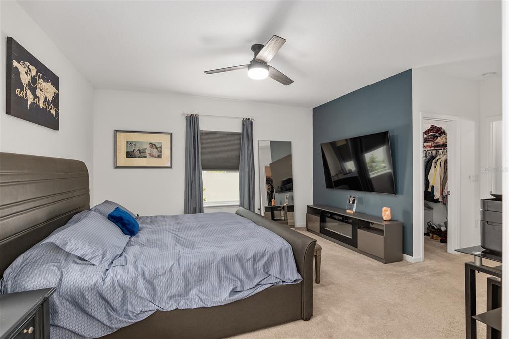 5688 Southwest 92nd Place Ocala, FL 34476 - Photo 28 of 54 a bedroom with a bed and a flat screen tv