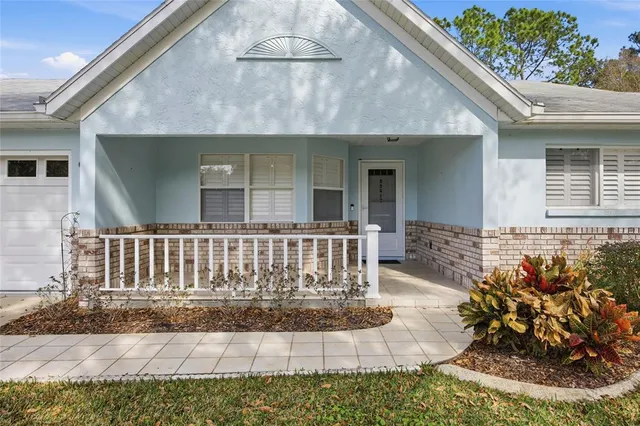 a view of a house with a yard and sitting area